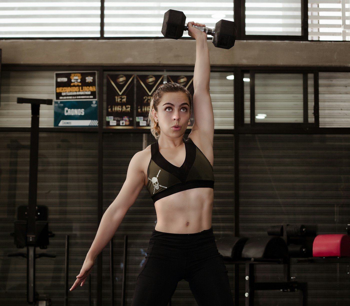 Woman raising a dumbbell during a gym workout